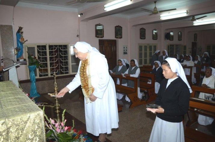 Lights the traditional lamp- prayer moment.JPG